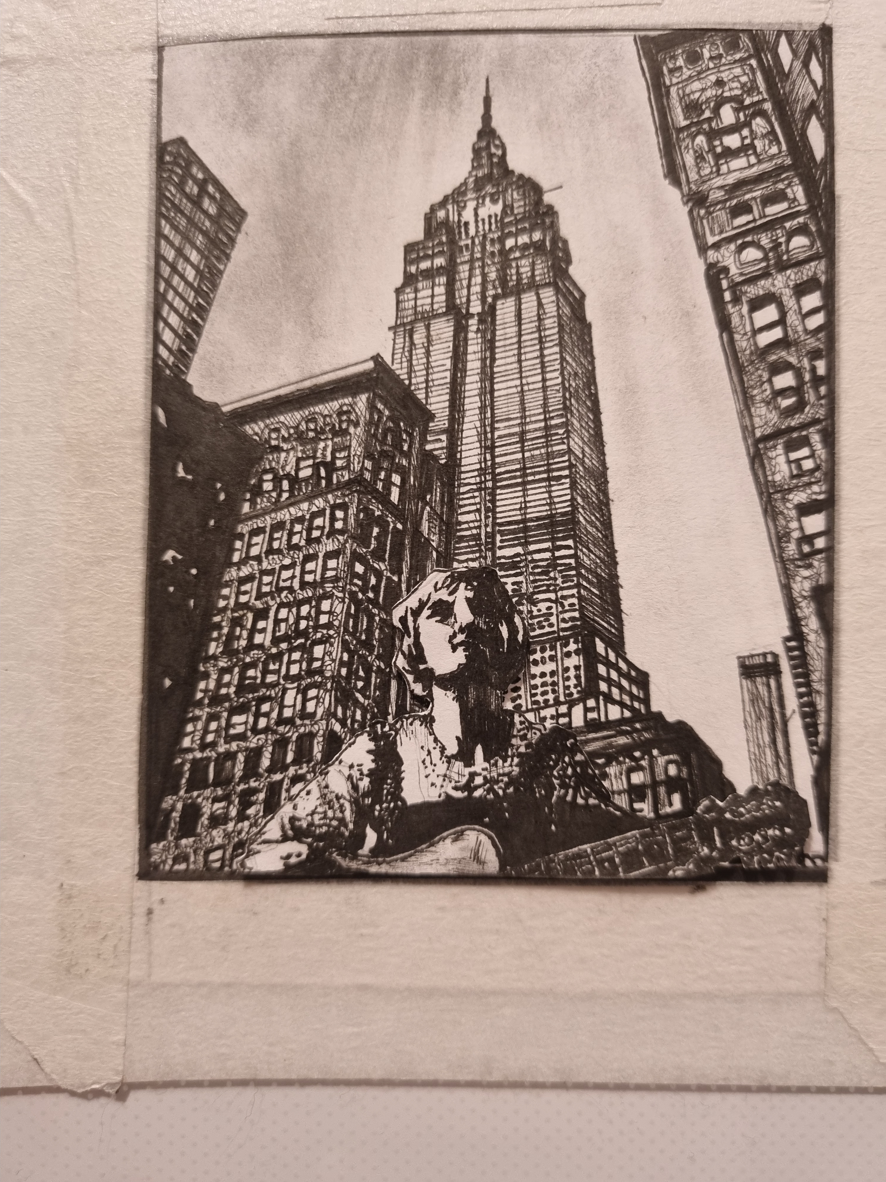 A monochrome guitar-playing figure sits at the base of a tall central tower, with closely drawn buildings rising on either side; the photograph includes the surrounding paper margin.