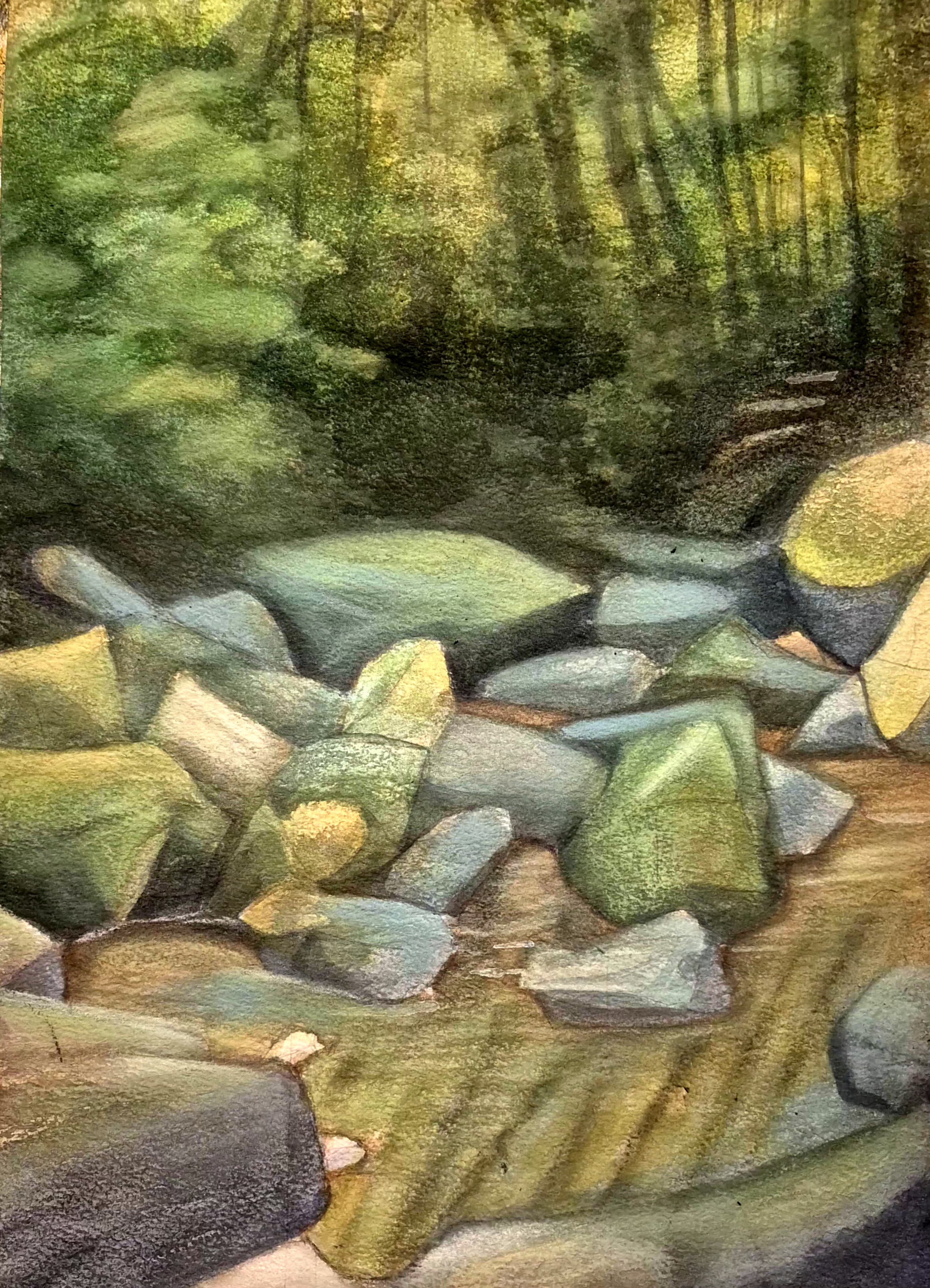 Woodland scene with blue-green and ochre rocks in the foreground beside shallow water, with dark tree trunks and green foliage behind.
